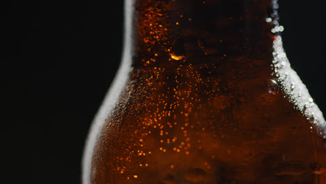 Close-Up-Of-Condensation-Droplets-On-Revolving-Bottle-Of-Cold-Beer-Or-Soft-Drink-1